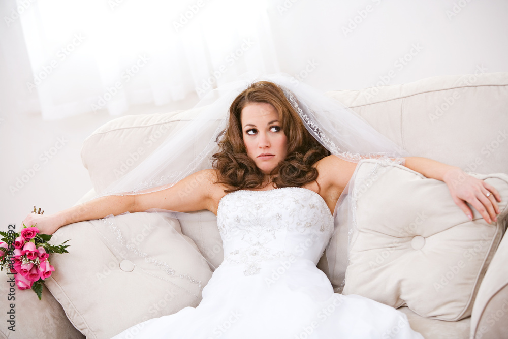 Bride: Annoyed Bride Sits On Couch with Bouquet Bride: Annoyed Bride Sits On Couch with Bouquet