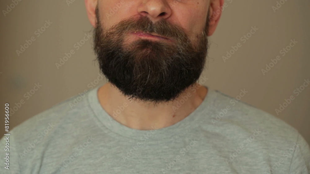 Beared man eats a hamburger and french fries Beared man eats a hamburger and french fries