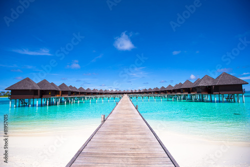 Fototapeta Water bungalows and wooden jetty on Maldives