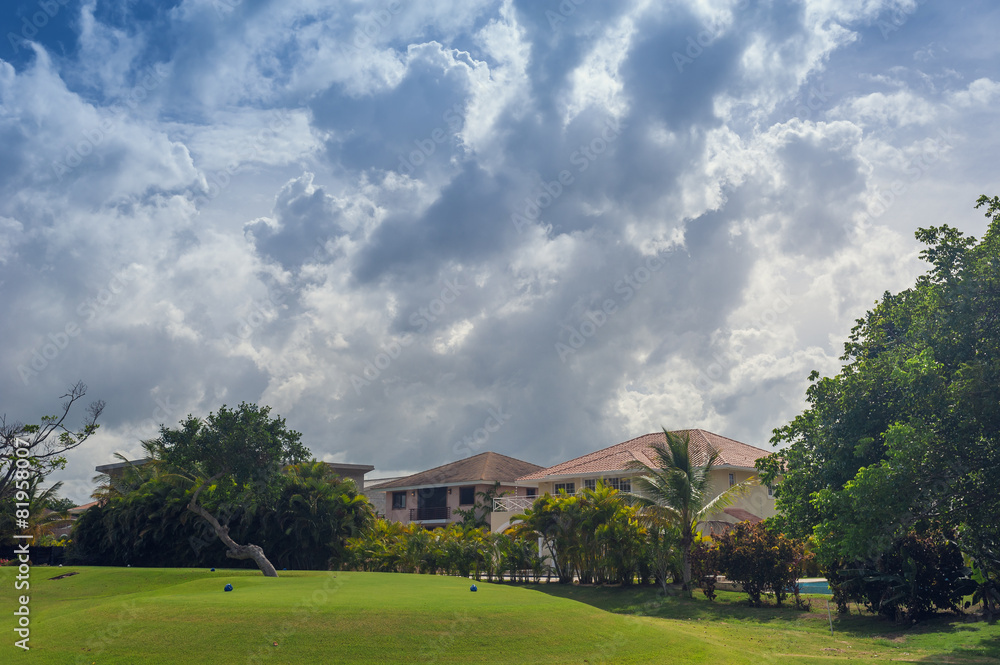 Fototapeta premium Golf course in Dominican republic. field of grass and coconut