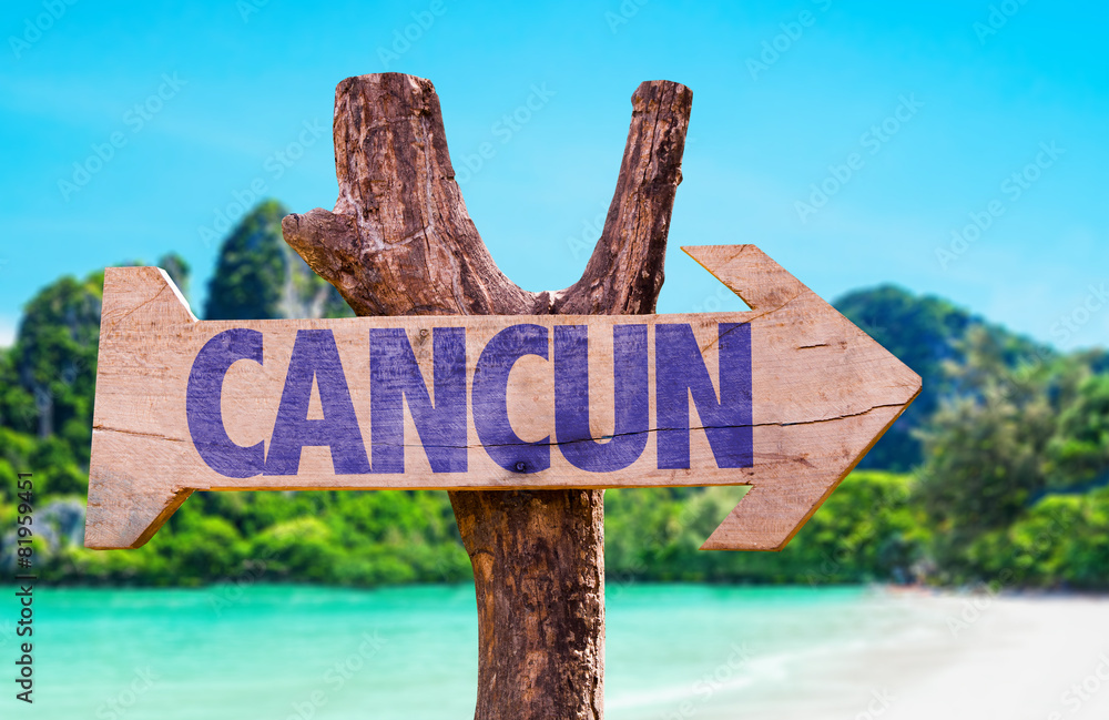 Cancun wooden sign with beach background
