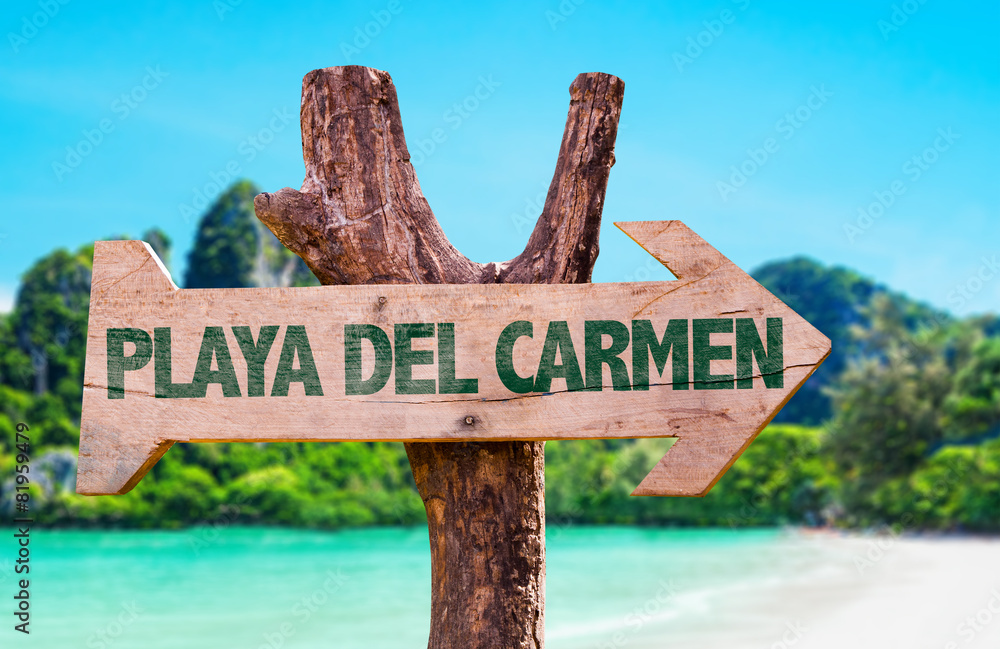 Playa Del Carmen wooden sign with beach background