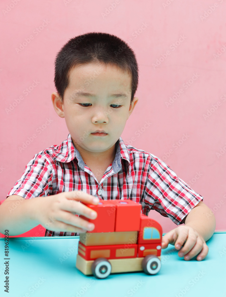The little boy playing with the building blocks. The little boy playing with the building blocks.