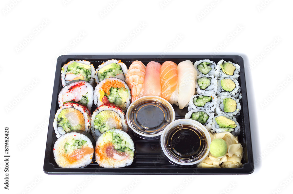 Assorted sushi rolls in a black plastic tray against white backg Assorted sushi rolls in a black plastic tray against white backg
