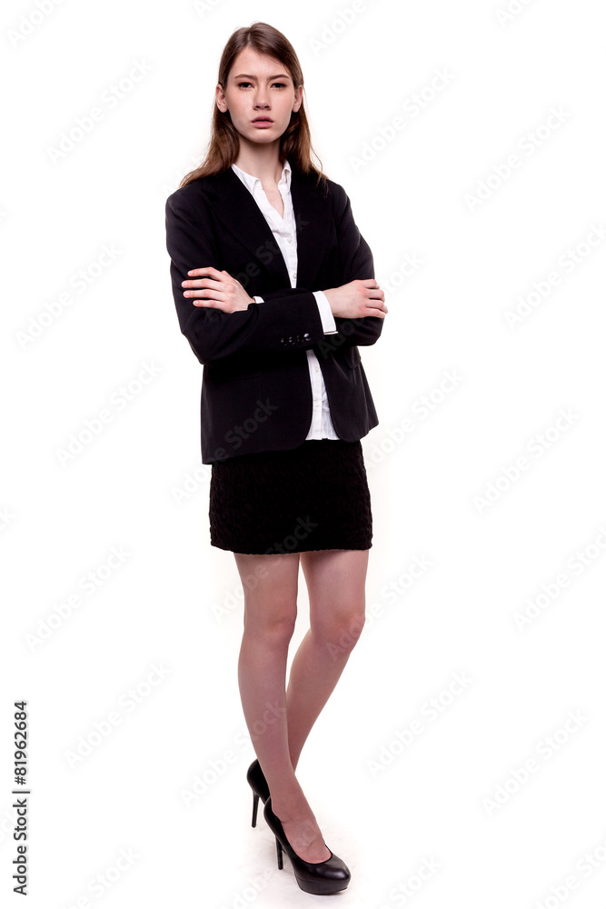 Attractive businesswoman standing arms crossed - Stock image Attractive businesswoman standing arms crossed - Stock image