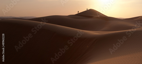 People walking in a dune's desert photo