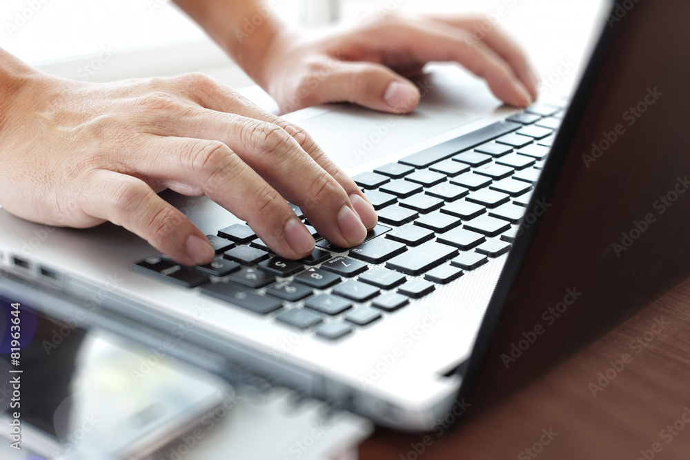 Young creative designer man working with laptop at office as con Young creative designer man working with laptop at office as con
