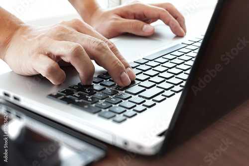 Young creative designer man working with laptop at office as con