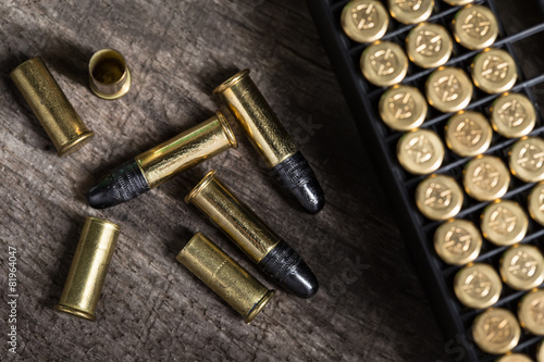 Scattering of small caliber cartridges on a wooden background
