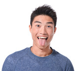 young man showing tongue, face expression on white background