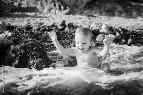 Happy toddler boy on the sea