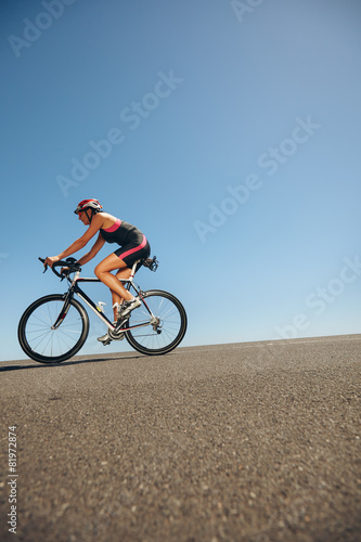 Female athlete training for cycling event of a triathlon