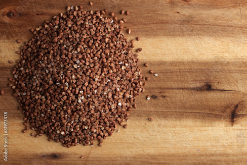 Grains of buckwheat on the kitchen board