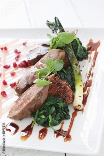 pan fried duck breast with polenta and spiniach photo