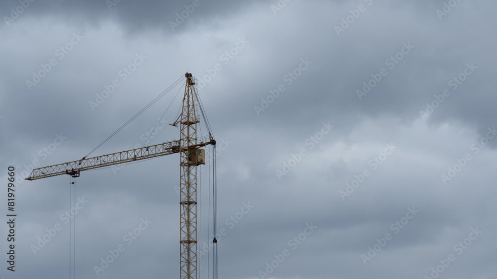 Crane on a background cloudy sky. Time Lapse 