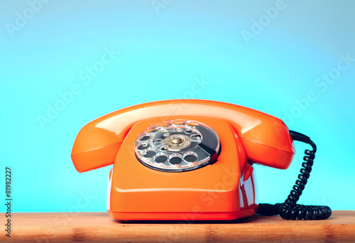 Vintage orange phone on the table