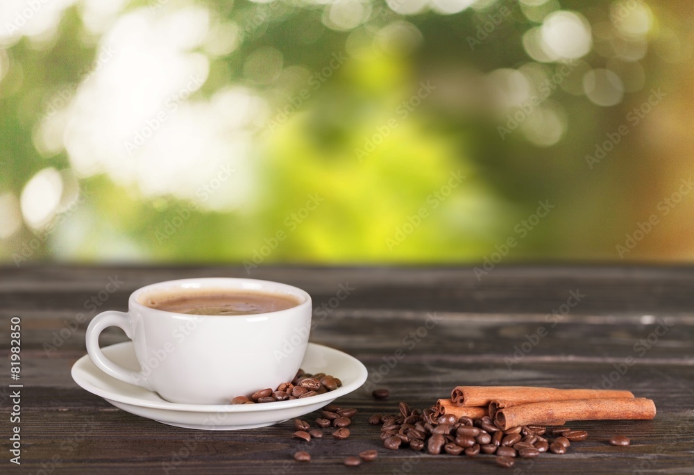 Obraz premium Cup. Cup of coffee with cinnamon and beans