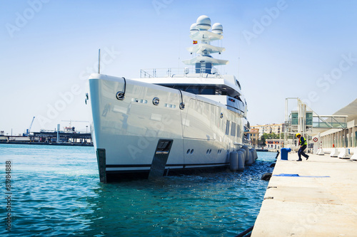 Luxury yacht docking at port.