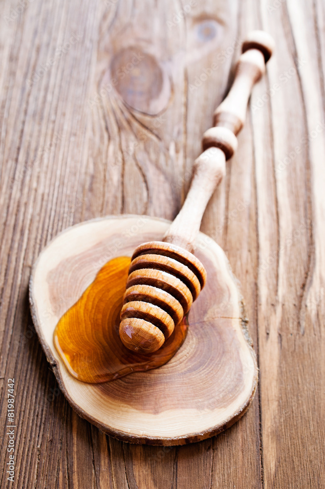 Honey with wooden dipper Honey with wooden dipper