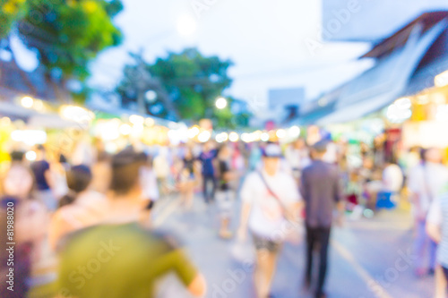 Blur tourists walk in shopping market