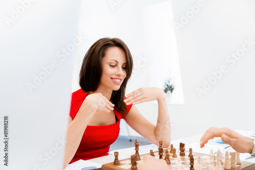 Business woman sitting in front of chess