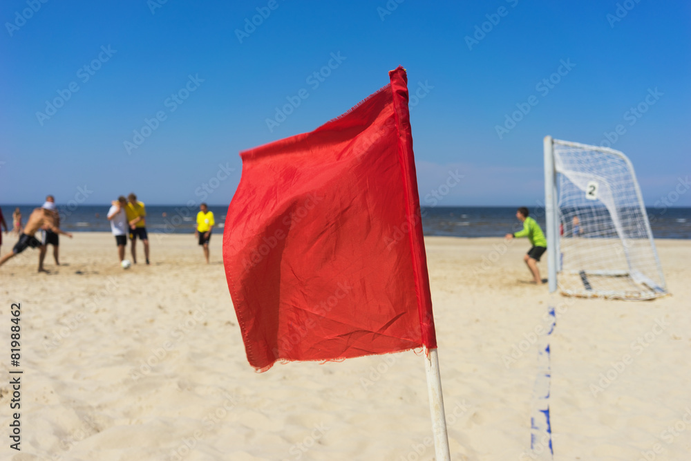 Red flag in a football field on the beach Red flag in a football field on the beach