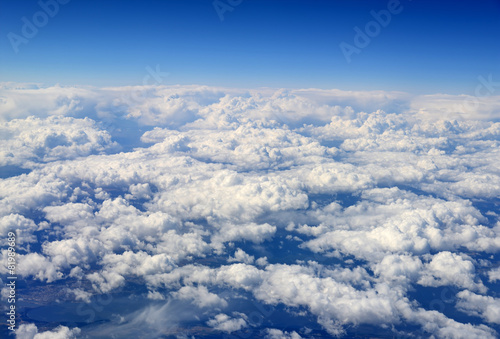 Fototapeta Naklejka Na Ścianę i Meble -  Clouds and sky as seen through window of an aircraft