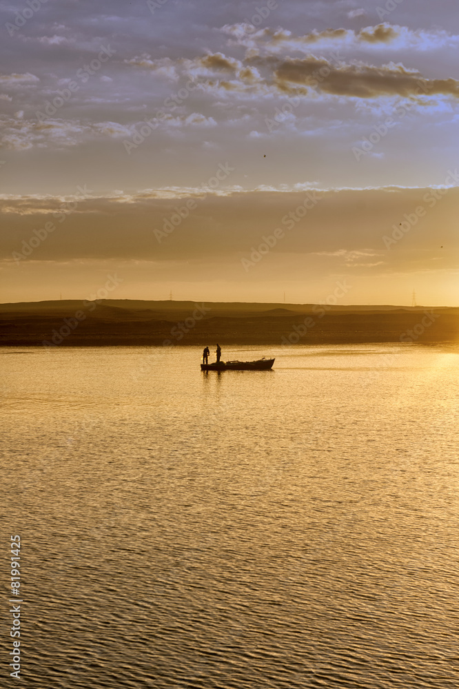 Traditional fishing boat at sunset in Suez canal, Egypt