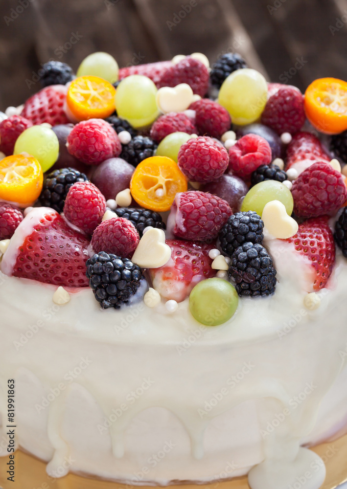 White chocolate cake decorated with fresh berries and fruits White chocolate cake decorated with fresh berries and fruits