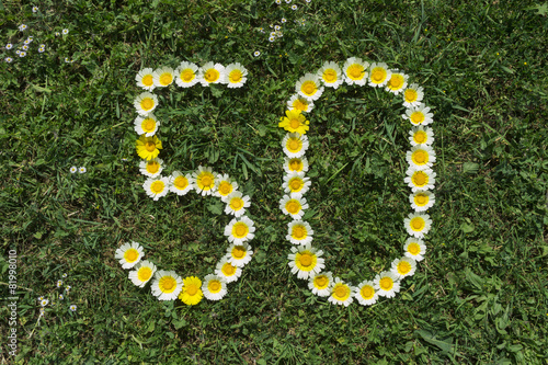 Numeral 50 of blossoms in gras
