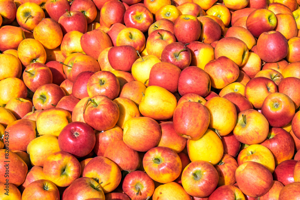 Red and yellow apples for sale at a market Red and yellow apples for sale at a market