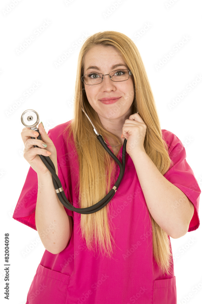 nurse in pink outfit with stethoscope out smiling nurse in pink outfit with stethoscope out smiling