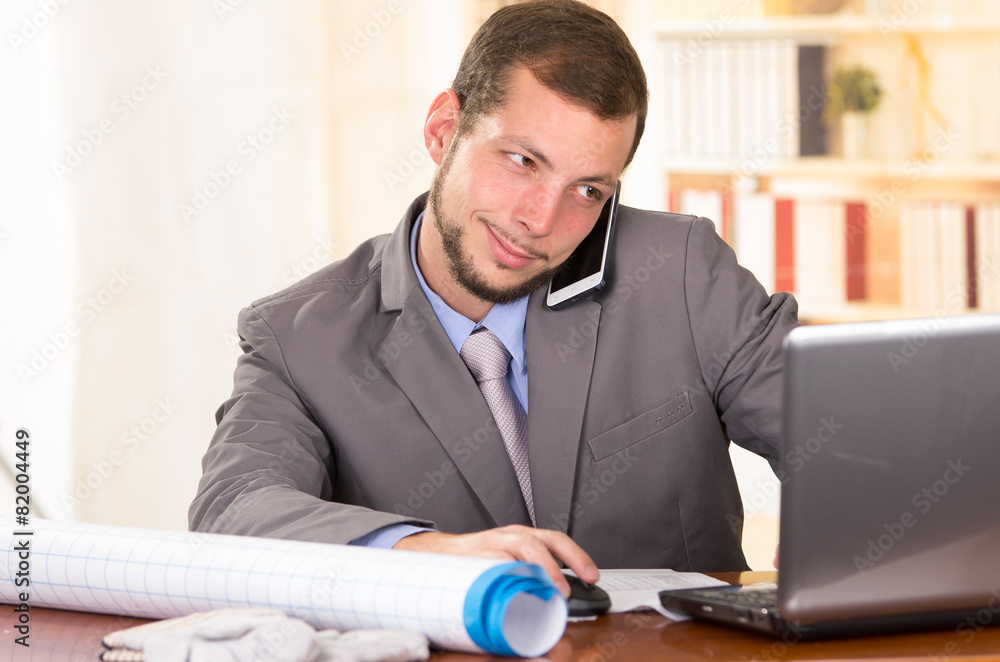 Naklejka premium young handsome architect working in an office