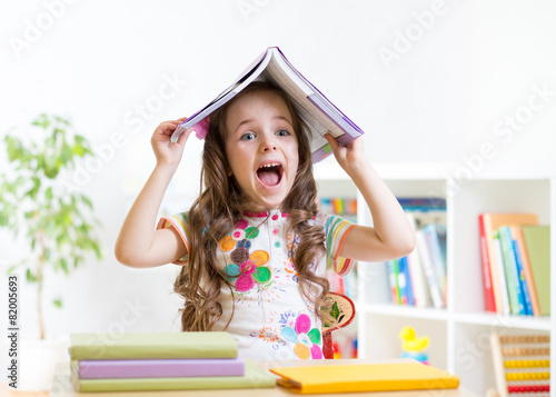 smiling child with a book o...