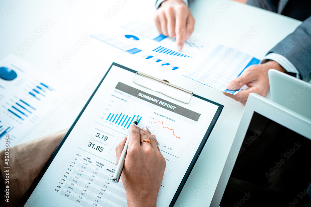 Business people discussing the charts and graphs showing the res Business people discussing the charts and graphs showing the res