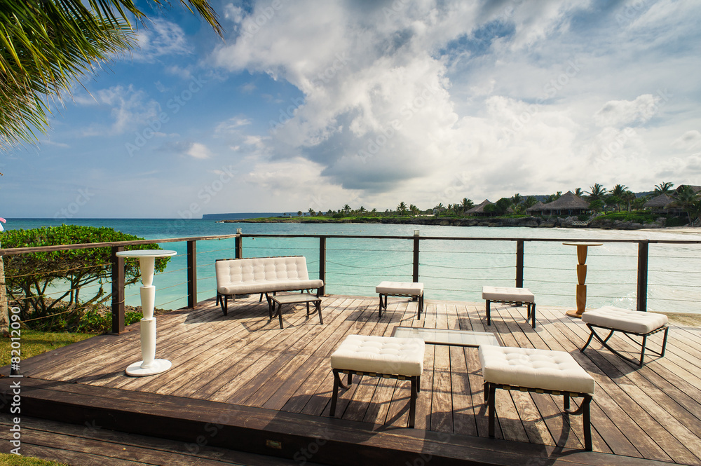 Outdoor restaurant at the seashore. Table setting in tropical Outdoor restaurant at the seashore. Table setting in tropical