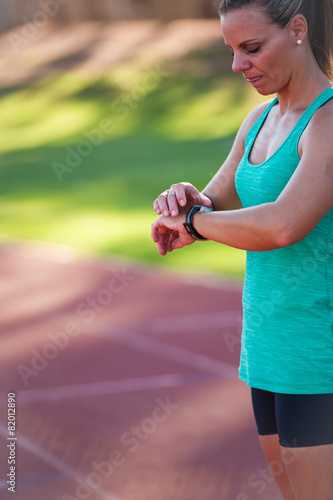 image of a female athlete adjusting her heart rate monitor