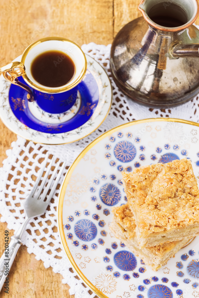 Homemade apple pie and coffee on wooden table