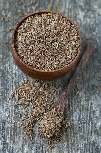 dried cumin on wooden surface photo