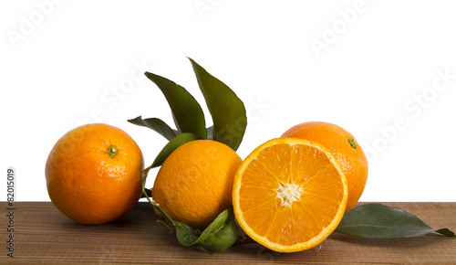 oranges with leaves on wood