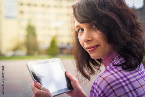 Young woman with Tablet reading