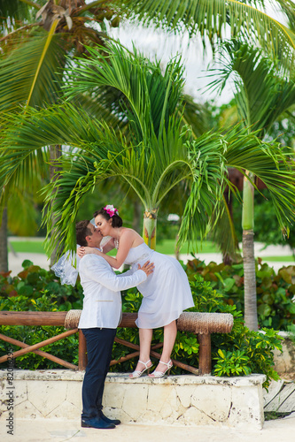 Young loving couple on tropical sea background - wedding at the
