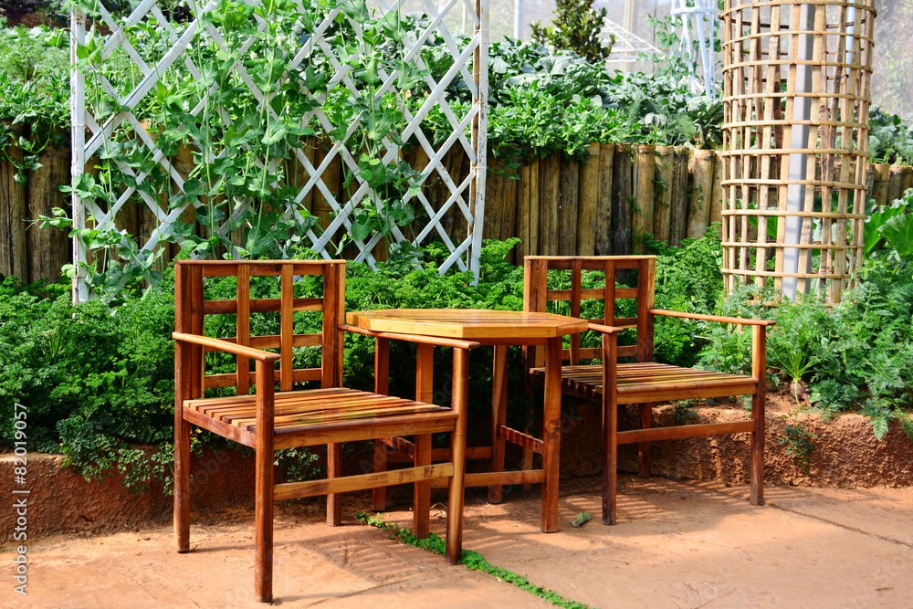 Wooden table and chair in vegetable garden. Wooden table and chair in vegetable garden.