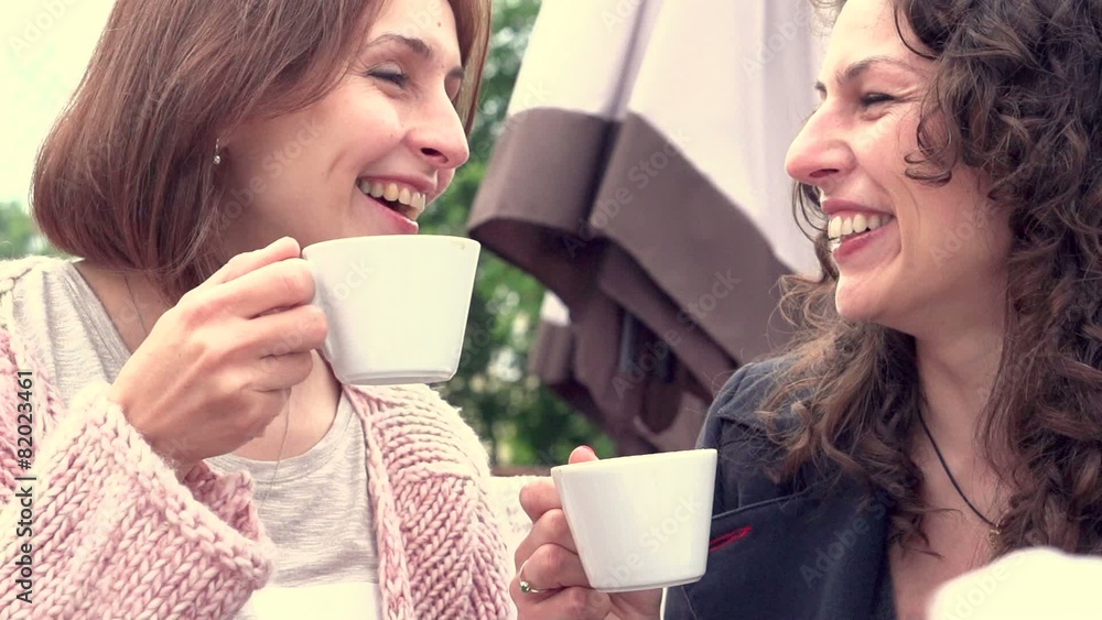 Beautiful women drinking coffee in cafe and talking Beautiful women drinking coffee in cafe and talking
