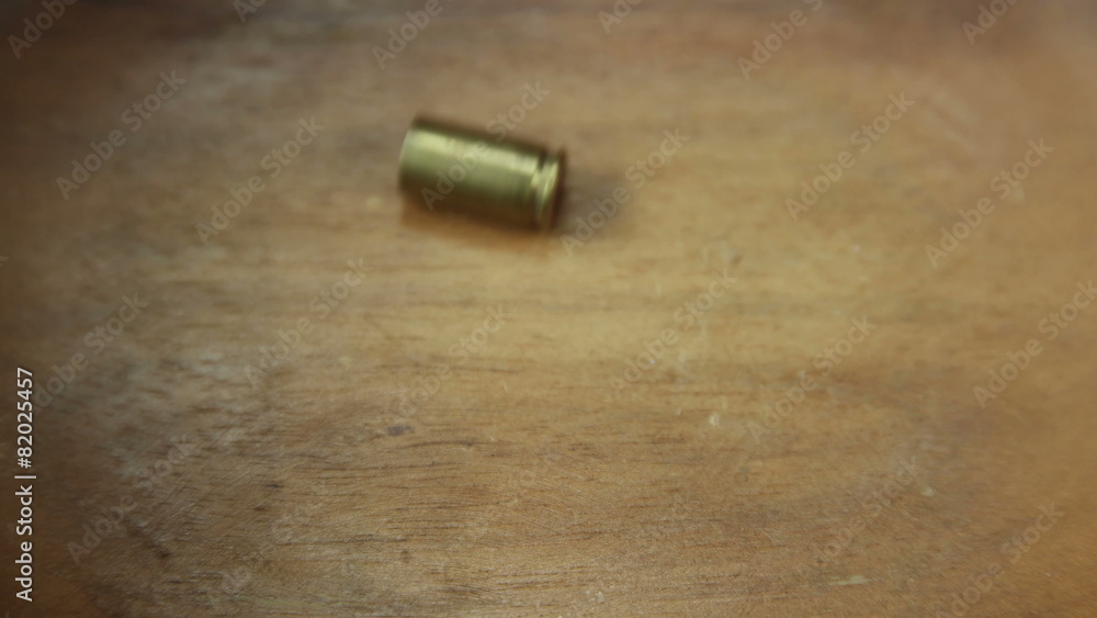 Bullet casing rocking back and fourth at center 4K UHD Bullet casing rocking back and fourth at center 4K UHD
