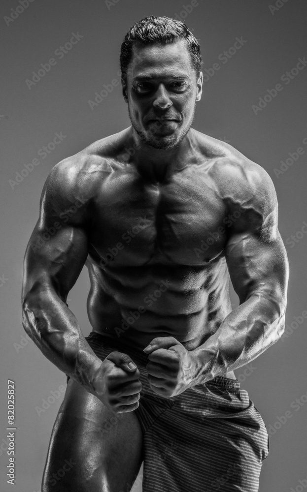 Awesome muscular guy posing in studio. Awesome muscular guy posing in studio.