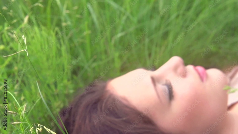 Beautiful girl lying on the meadow and dreaming Beautiful girl lying on the meadow and dreaming