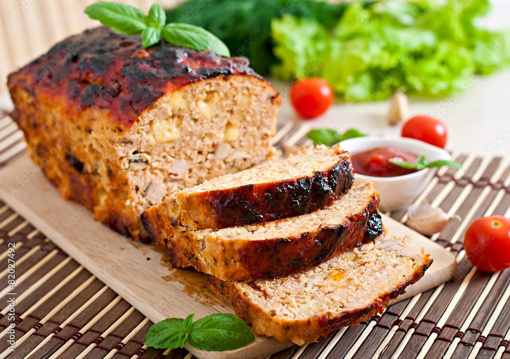 Homemade ground meatloaf with ketchup and basil Homemade ground meatloaf with ketchup and basil