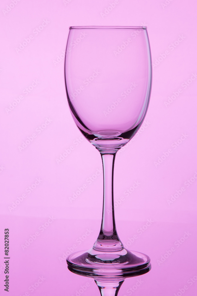 glass with wine on pink background glass with wine on pink background