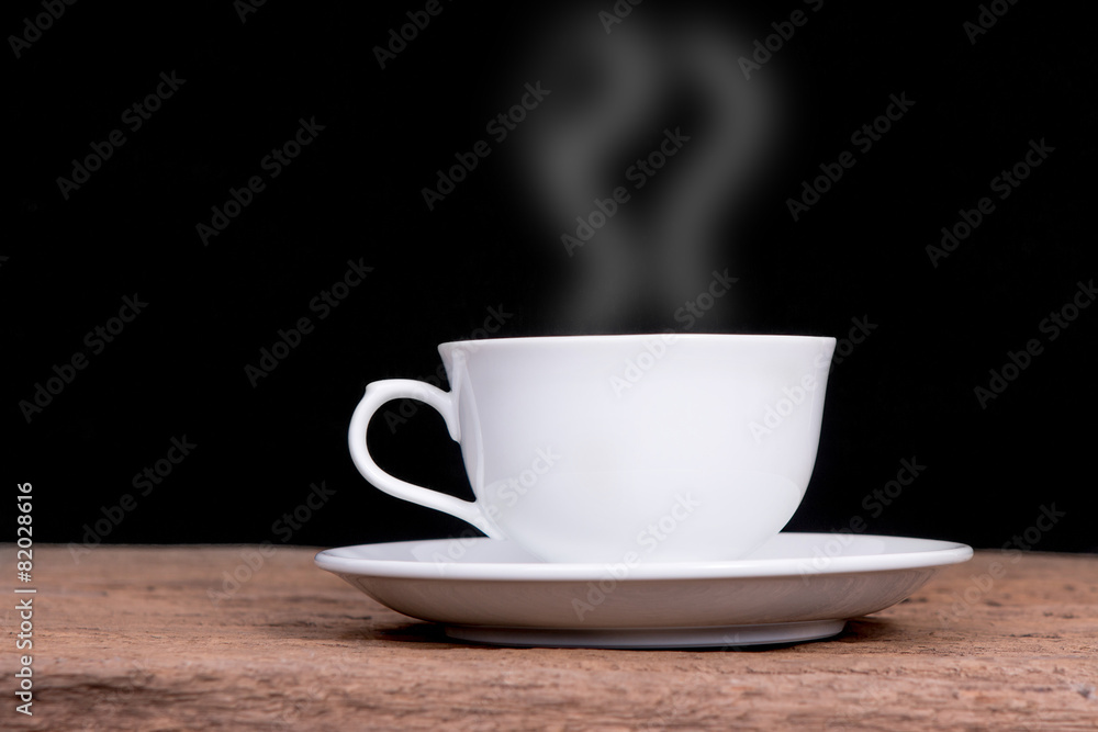 white cup with hot liquid and steam on black white cup with hot liquid and steam on black